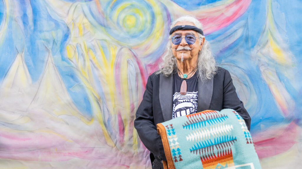 Joseph M. Sánchez in front of the Spirit of Bison mural